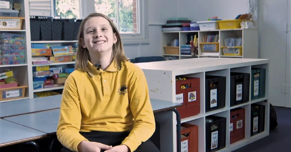 Year 6 student Aidan smiling sitting in a classroom