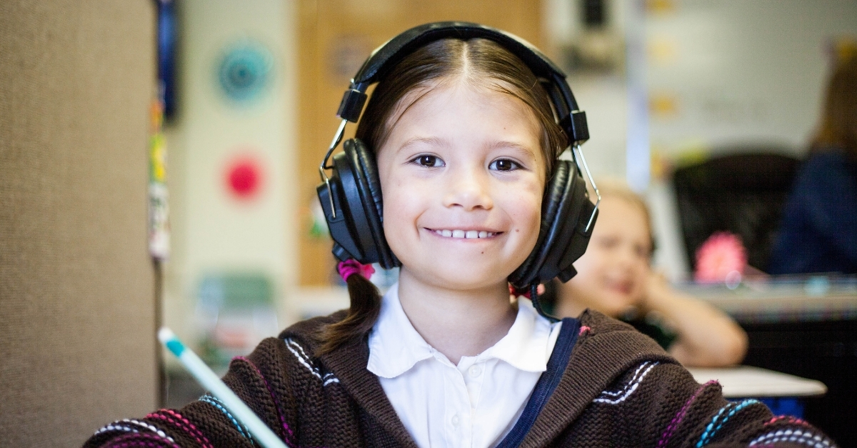Student smiling with headphones on